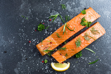 Wall Mural - Salmon fish fillets on dark marble table