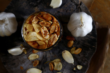 Toasted peanuts and fried garlic chips on a glass