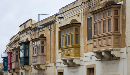 Canvas Print - Traditional, wooden balcony and stone facade, typical for architecture of Gozo, Malta