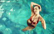 © majdansky - Sensual woman realxing in a hot, tropical pool