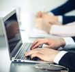 © rogerphoto - Group of business people working together in office. Man hands typing on laptop computer