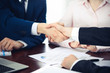 © rogerphoto - Business people shaking hands finishing up a meeting. Handshake at successful negotiation