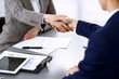 © rogerphoto - Business people shaking hands, finishing up a meeting. Papers signing, agreement and lawyer consulting concept