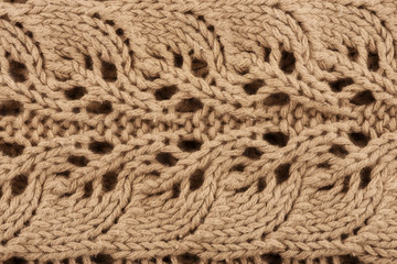 Wall Mural - Close up on a beige knitted sweater as the background. Fashion design. Macro.