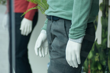 Wall Mural - closeup of green and red pullover on mannequin in fashion store showroom for men