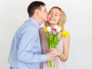 Man gives a bouquet of flowers to woman