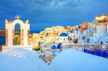 Oia town on Santorini island, Greece. Traditional and famous houses and churches with blue domes over the Caldera, Aegean sea