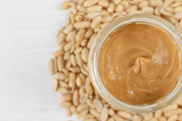 Wall Mural - peanuts and peanut butter in a jar on the table