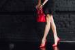 © Тарас Нагирняк - Beautiful slender womanish feet in red shoes and mini bag!