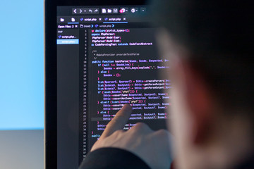 Wall Mural - programmer working on laptop computer in office