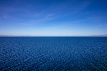 Greece. Aegean sea. Blue sky and calm sea water texture background