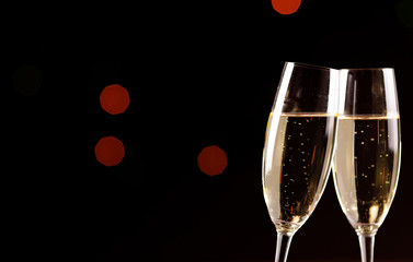 Wall Mural - Champagne glasses on black background. Holiday celebration concept.