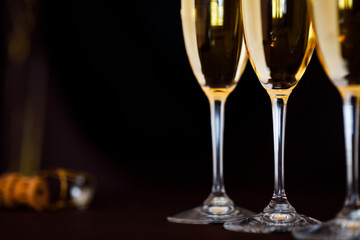 Wall Mural - glasses of champagne on black  background with bokeh circles. Place for text.