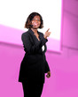 © TheVisualsYouNeed - confident black African American business woman with microphone speaking in auditorium at corporate seminar event giving success coaching conference or political rally