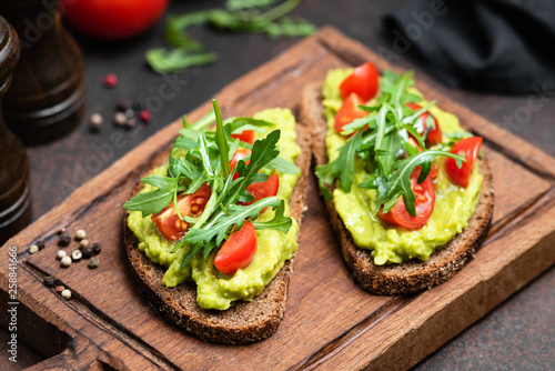 Fotomural Vegan or Vegetarian Toast with mashed avocado, arugula served on wooden board