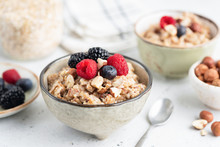 Healthy Breakfast Cereal Porridge With Berries And Nuts In Bowl. Closeup View.