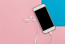 Headphones And Smartphone On Pink And Blue Background