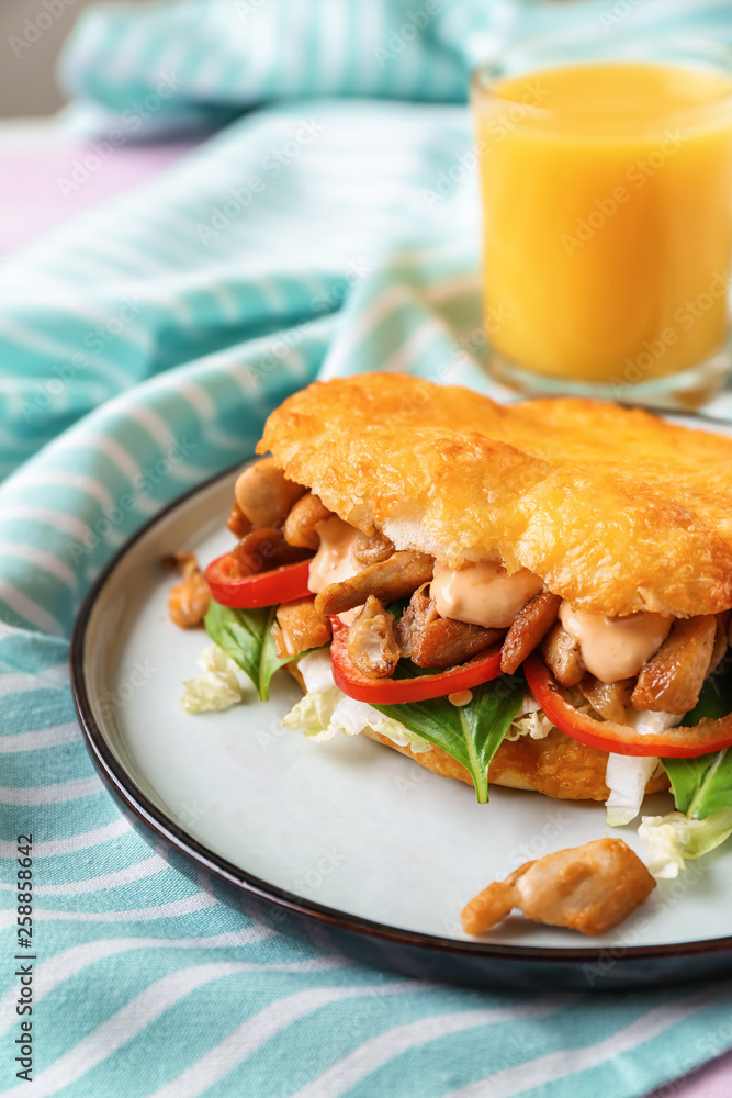 Plate with tasty doner kebab on table