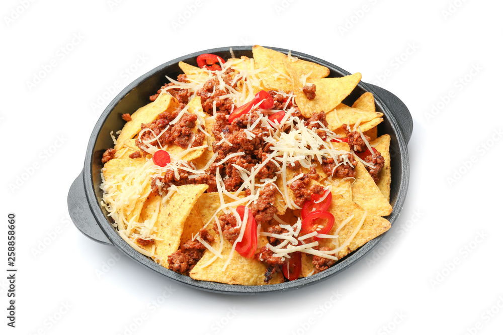 Frying pan with tasty nachos, meat and cheese on white background
