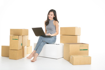 Young woman freelancer working and checklist and writing order with cardboard box on white background - SME business online and delivery concept