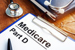 © Vitalii Vodolazskyi - Medicare Part D documents with clipboard on a desk.
