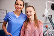 © gpointstudio - Portrait of smiling orthodontist and child in dentist's office