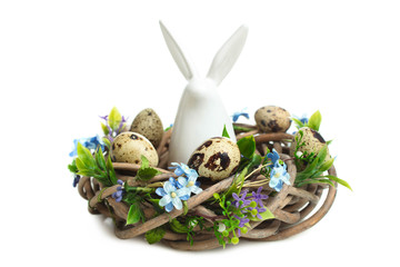 Canvas Print - decorative easter bunny sitting in nest with quail eggs