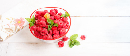 Wall Mural - Ripe sweet raspberries in bowl on wooden table. Close up, top view, high resolution product