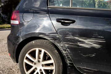 Black modern car scratched in traffic accident