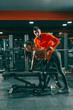 © Dusan Petkovic - Young sporty woman doing exercises on the bench while her personal trainer helping her. Gym at night interior. If you don't live for something you'll die for nothing.