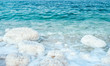 .incredibly beautiful seaside of the dead sea with blue water and white crystals of salt near.selective focus