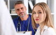 © kuprevich - Smiling handsome mature doctor communicate with patient
