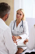 © kuprevich - Female family doctor listen carefully young couple