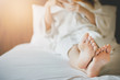 © Lek - Closeup of foot with young asian woman on bed