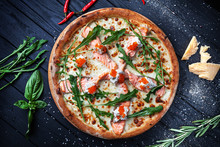 Top View On Fresh Homemade Italian Pizza With Salmon And Caviar. Pizza, Cheese, Cherry Tomato And Parsley On Dark Wooden Background With Copy Space For Design. Top View Food Menu, Recipe