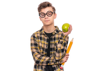 Poster - Portrait of Handsome Thoughtful Teen Boy in funny eye Glasses holding Big Pencil and Apple. Young Student - ponder and dreaming, isolated on white background. Back to School and childhood concept.