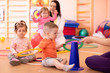 © Oksana Kuzmina - Nursery babies group doing sport in gym