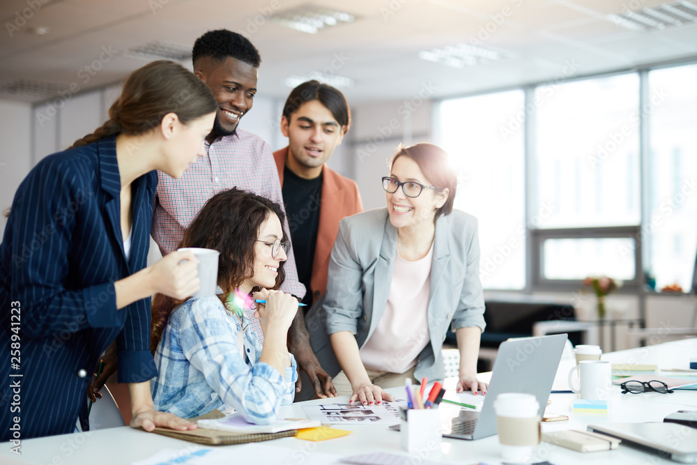 Portrait of creative business team collaborating on visual project in ...