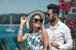 © Semachkovsky  - young fashion couple in sunglasses standing and posing at the camera on sunny summer day.Trip to warm destination. Honeymoon.Beautiful sea and floral landscape. Phuket. Thailand.