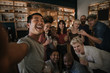© mavoimages - Friends having fun and taking selfies in a bar