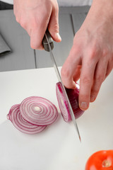 Wall Mural - Man slicing a red onion