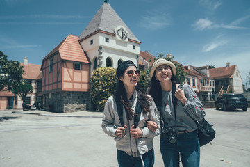 Wall Mural - Group of asian women walking in Copenhagen denmark. Happiness and friendship concepts. smiling girls travel backpacker with professional camera walking outdoor city street cheerful laugh hold hands