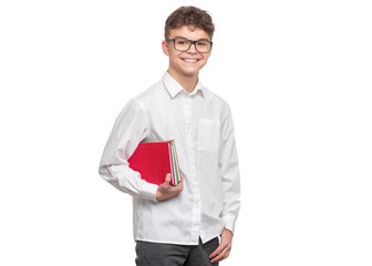 Poster - Handsome Student Teen Boy in Eyeglasses with Books. Portrait of School Teenager holding books, isolated on white background. Happy smiling college child looking at camera.