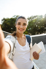 Sticker - Cheerful young student girl carrying backpack