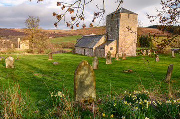 Canvas Print - Graveyard at Edlingham Church, known as St John the Baptist medieval church set in the hamlet of Edlingham in the Northeast English county of Northumberland