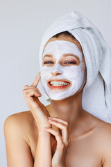 Wall Mural - beautiful young woman applying facial mask on her face. skin care and treatment, spa, natural beauty