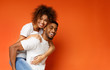 © Prostock-studio - Happy african-american man and woman riding piggyback