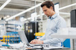 © Westend61 - Businessman using laptop in a factory