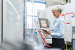 © Westend61 - Smiling senior businesswoman using tablet in a factory