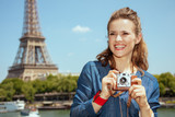 Fototapeta Paryż - solo tourist woman with retro photo camera looking into the dist